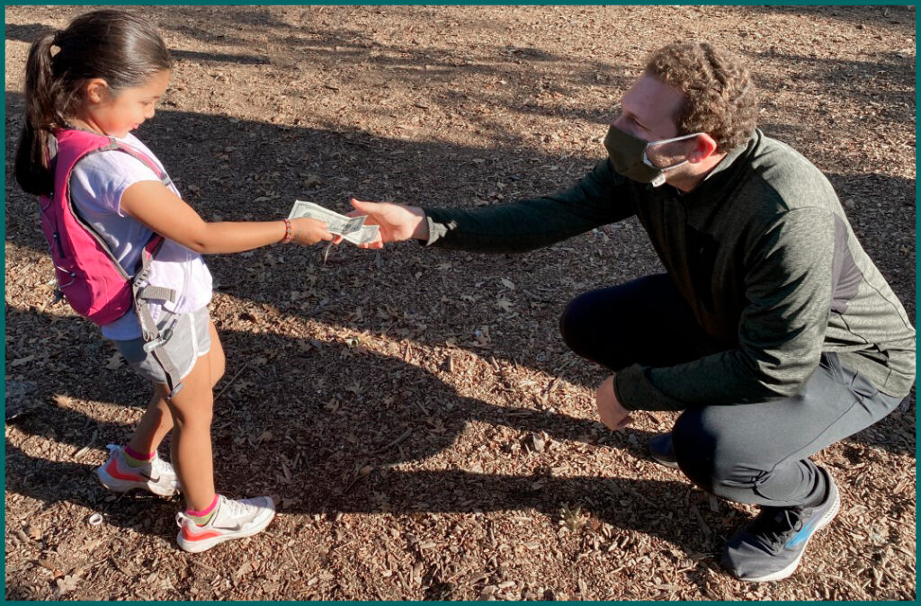 Lucia Estrada presenting her donation to Steve Diamond, our Executive Director at Family Day for Matrix Mighty Milers 2021.
