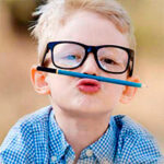 little boy balancing pencil on upper lip