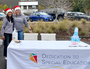 Keely from Matrix joining another volunteer at the Dedication to Special Education table.